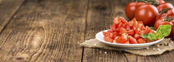 Diced Tomatoes on a vintage background as detailed close-up shot (selective focus)