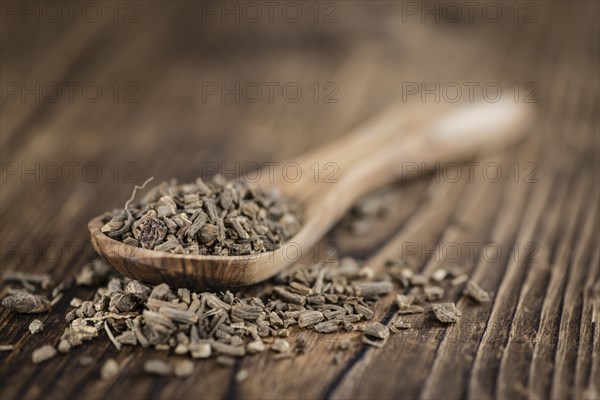 Dried Valerian roots (detailed close-up shot) on wooden background