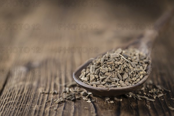 Heap of valerian roots (close-up shot) on vintage wooden background