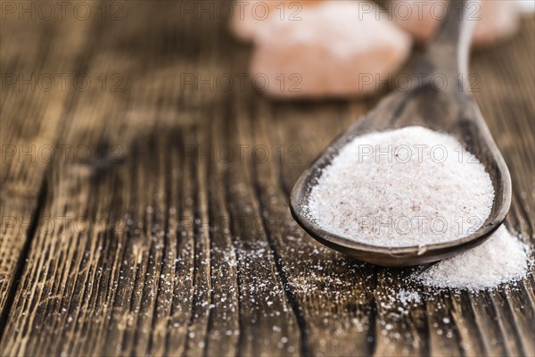 Pink Himalayan Salt on an old wooden table as detailed close-up shot (selective focus)