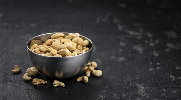 Some roasted Cashew Nuts as detailed close up shot (selective focus)