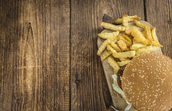 Wooden table with a homemade Falafel Burger (selective focus)