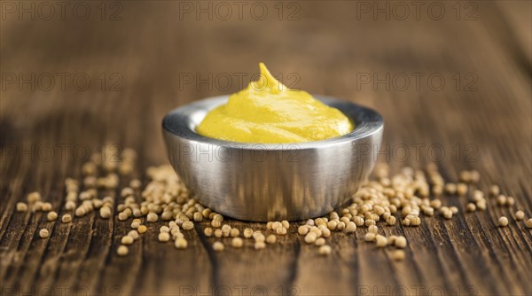 Mustard on a vintage background as detailed close-up shot (selective focus)