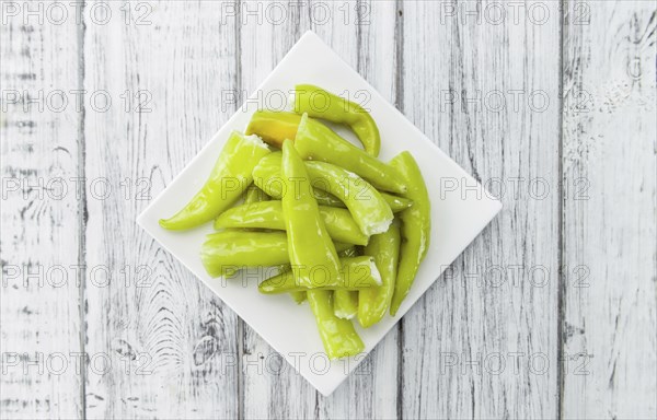 Fresh made Green Chilis (filled with cheese) on a vintage background (close-up shot)
