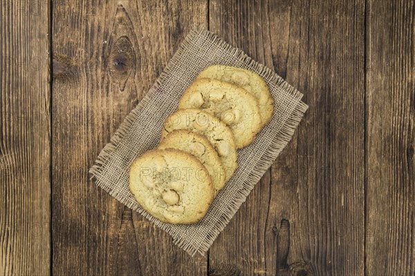 Vintage wooden table with Cookies (selective focus, close-up shot)