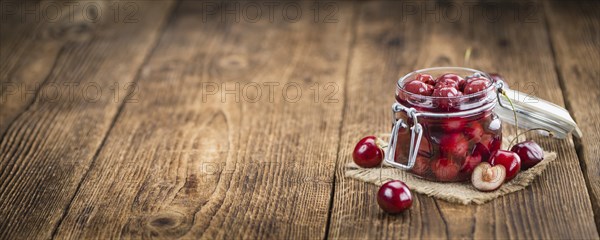 Fresh made Canned Cherries on a vintage background as detailed close-up shot