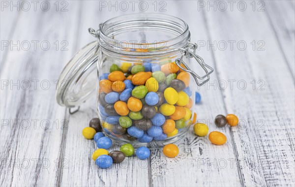 Portion of sweets (chocolate coated peanuts) as detailed close-up shot, selective focus