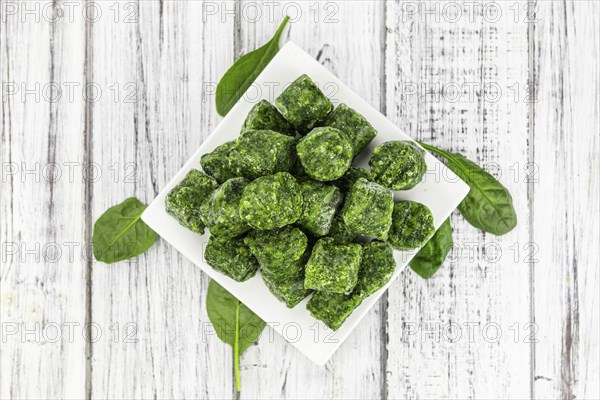 Frozen spinach cubes as detailed close up shot (selective focus)