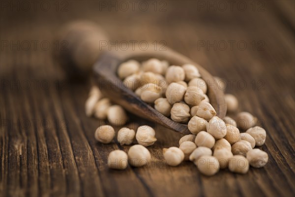 Chickpeas on a vintage background as detailed close-up shot, selective focus