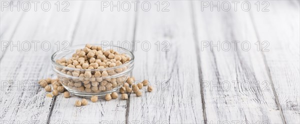 Chickpeas on an old wooden table as detailed close-up shot, selective focus