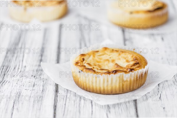 Fresh made Mini Cheesecake on a vintage background (close-up shot)