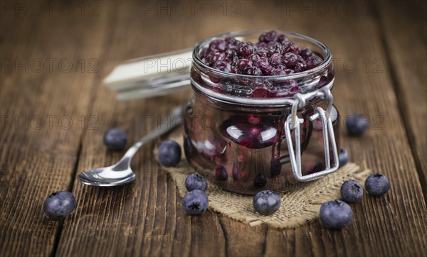 Homemade Preserved Blueberries on an wooden table as detailed close-up shot, selective focus