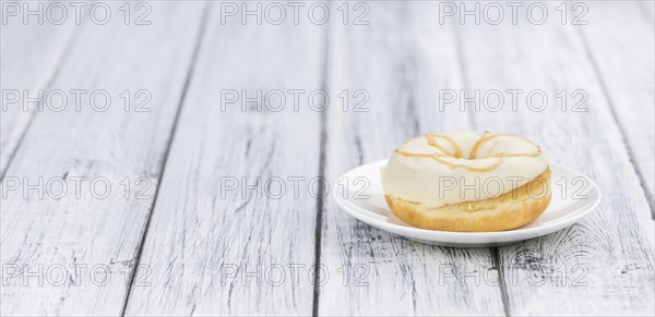 Some fresh made white chocolate Donuts (selective focus, close-up shot)