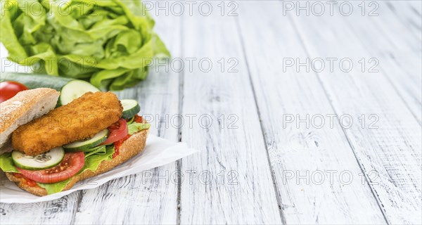 Chicken Schnitzel on a bun (selective focus, detailed close-up shot)