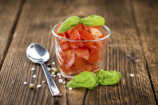 Homemade Cutted Tomatoes on vintage background (selective focus, close-up shot)
