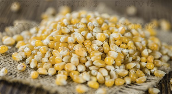 Portion of Corn (detailed close-up shot) on wooden background (selective focus)