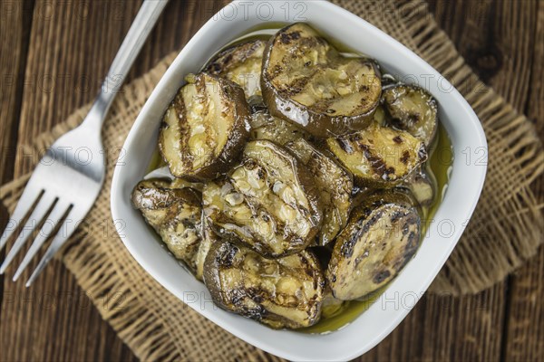 Fresh made Zucchinis (grilled) on an old and rustic wooden table (selective focus, close-up shot)