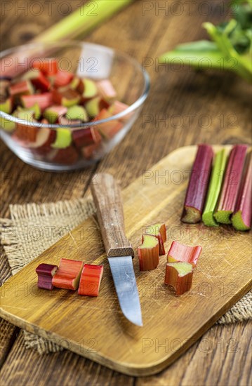 Chopped Rhubarb on an old wooden table (close up shot, selective focus)