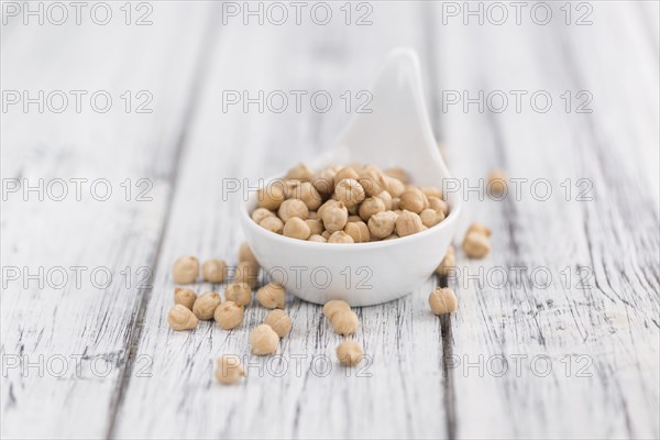 Chickpeas on a vintage background as detailed close-up shot, selective focus