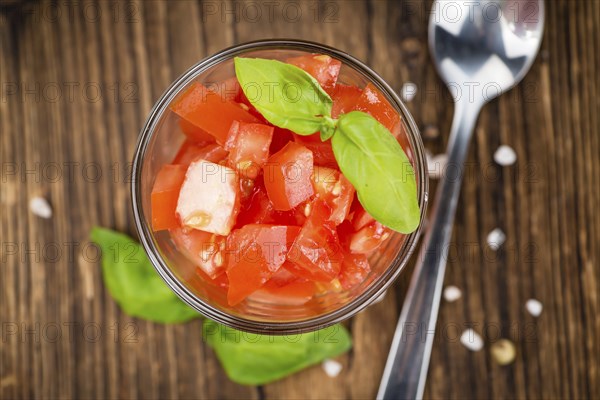 Diced Tomatoes on a vintage background as detailed close-up shot (selective focus)