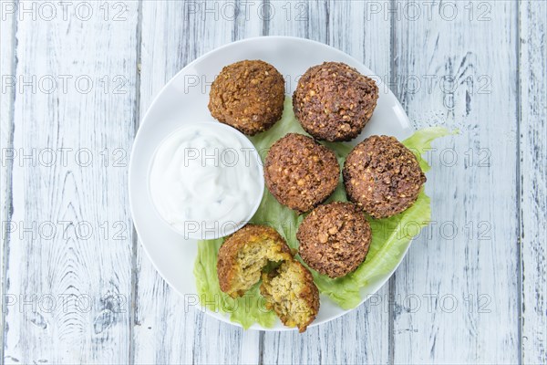 Portion of Falafel on an old wooden table (close-up shot, selective focus)