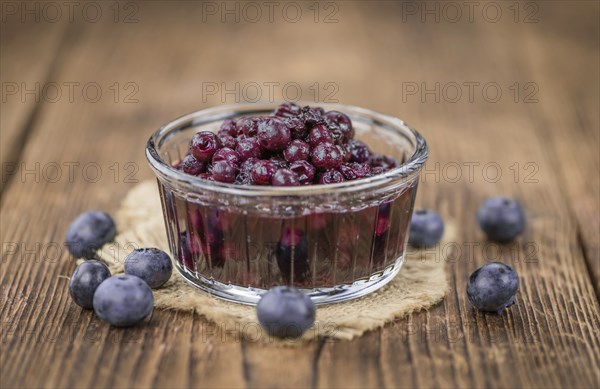 Preserved Blueberries on a vintage background as detailed close-up shot, selective focus