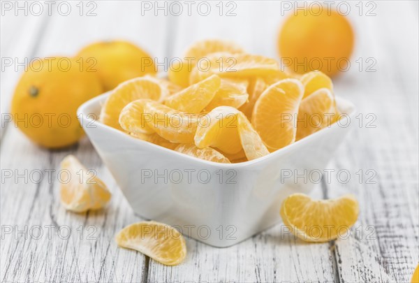 Raw Tangerine pieces (close-up shot) on vintage background