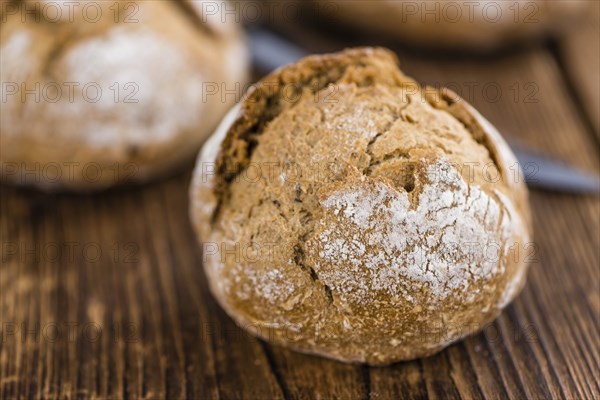 Wholemeal Roll on a vintage background as detailed close-up shot (selective focus)
