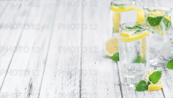 Lemonade on a vintage background as detailed close-up shot (selective focus)