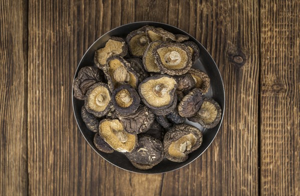 Dried Shiitake on a vintage background as detailed close-up shot, selective focus