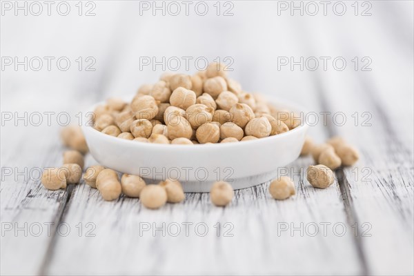 Chickpeas on a vintage background as detailed close-up shot, selective focus