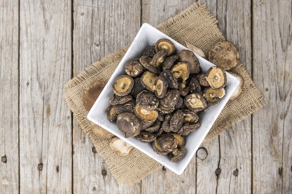 Dried Shiitake on a vintage background as detailed close-up shot, selective focus