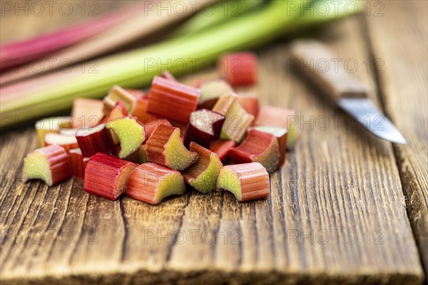 Chopped Rhubarb on an old wooden table (close up shot, selective focus)