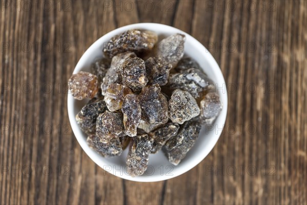 Brown Rock Candy on wooden background (selective focus, close-up shot)