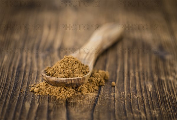 Fresh made Cinnamon Powder on a vintage background (close-up shot)
