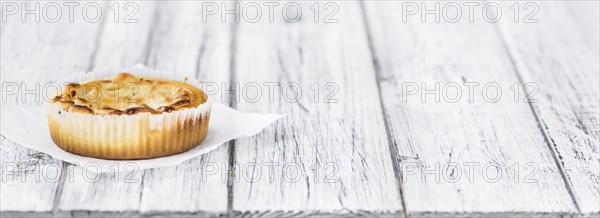 Fresh made Mini Cheesecake on an old and rustic wooden table (selective focus, close-up shot)