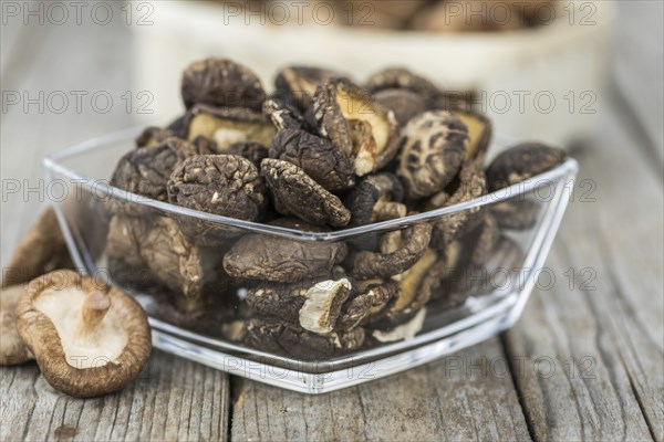 Homemade Dried Shiitake on an wooden table as detailed close-up shot, selective focus