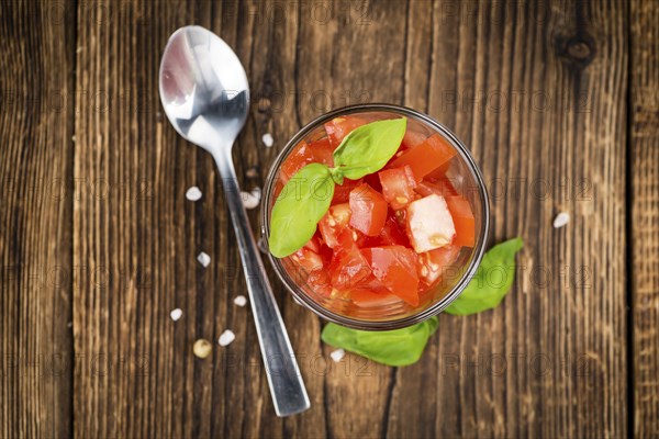 Homemade Diced Tomatoes on an wooden table (selective focus) as detailed close-up shot