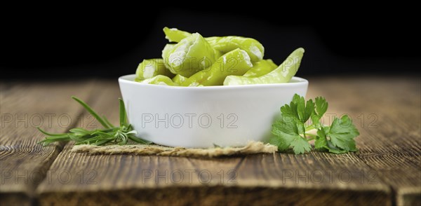 Fresh made Green Chilis (filled with cheese) on a vintage background (close-up shot)