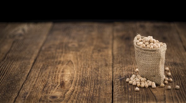 Chickpeas on a vintage background as detailed close-up shot, selective focus
