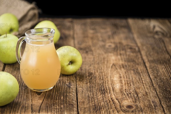 Fresh made Juice (apple) on a vintage background (close-up shot)
