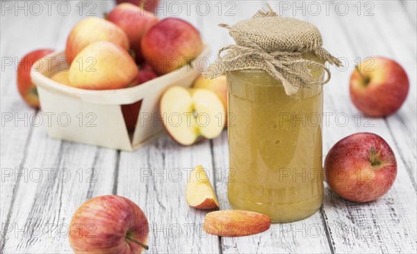 Homemade Applesauce (selective focus, close-up shot) on vintage background with some fresh fruits