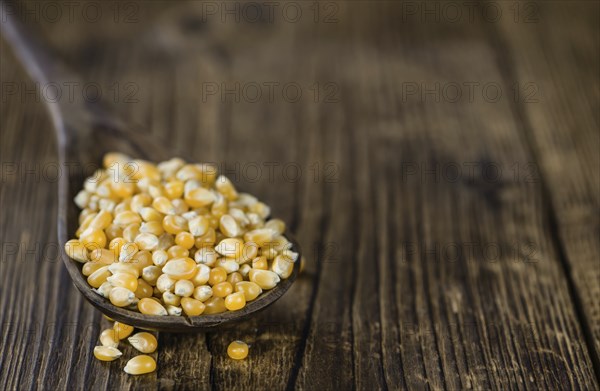 Dried Corn on a wooden table (detailed close-up shot, selective focus)