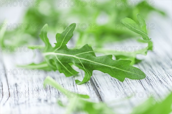 Portion of fresh Arugula (detailed close-up shot, selective focus)