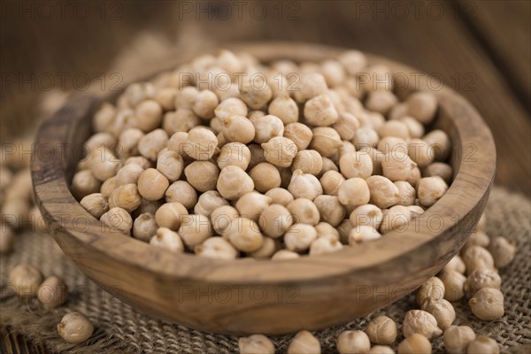 Chickpeas on an old wooden table as detailed close-up shot, selective focus