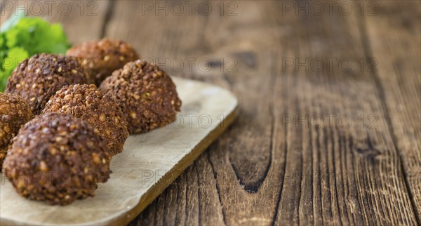 Portion of Falafel on an old wooden table (close-up shot, selective focus)