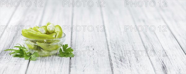 Fresh made Green Chilis (filled with cheese) on a vintage background (close-up shot)