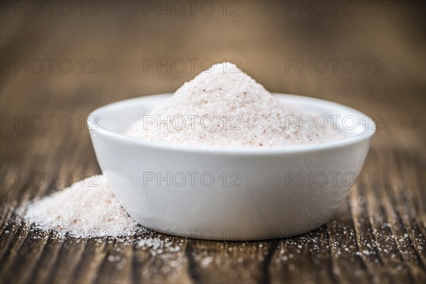 Pink Salt on a vintage background as detailed close-up shot (selective focus)