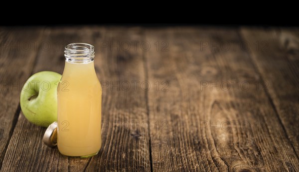 Fresh made Juice (apple) on a vintage background (close-up shot)