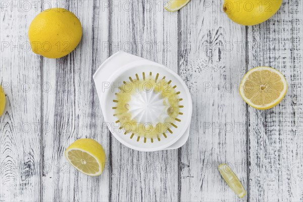 Homemade Lemon Juice on an wooden table (selective focus) as detailed close-up shot